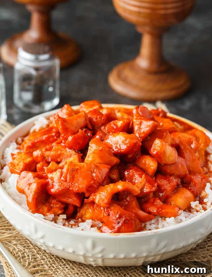 Russian Chicken - Sweet and tangy! This easy dinner recipe has a flavorful sauce made with Russian dressing, onion soup mix and apricot jam. Serve on a bed of rice for a delicious family meal.