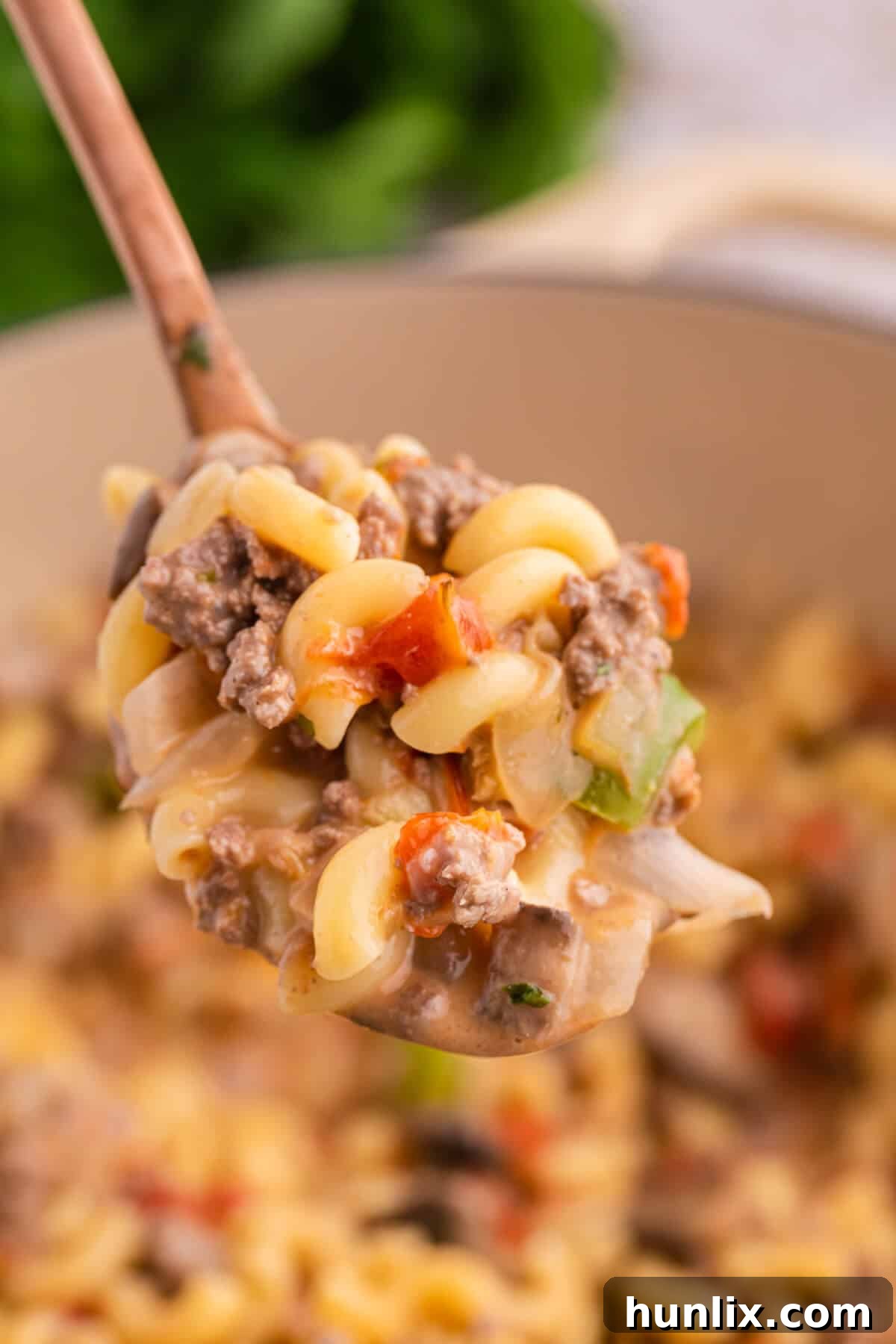 Mom's Heartwarming Macaroni 4 A spoonful of Mom's Macaroni, showcasing the cheesy, meaty, and saucy texture.