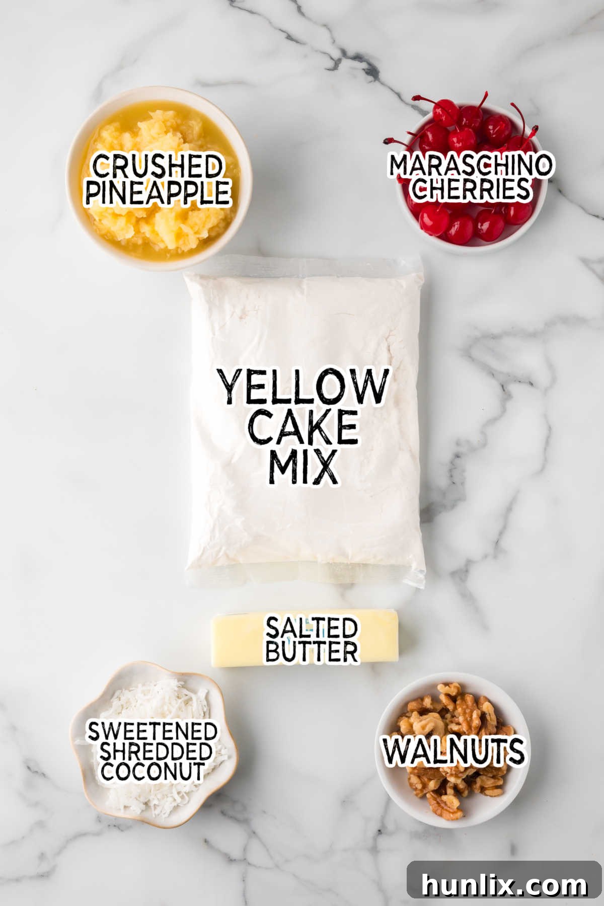 Collection of fresh ingredients for Fool's Cake on a clean marble background.