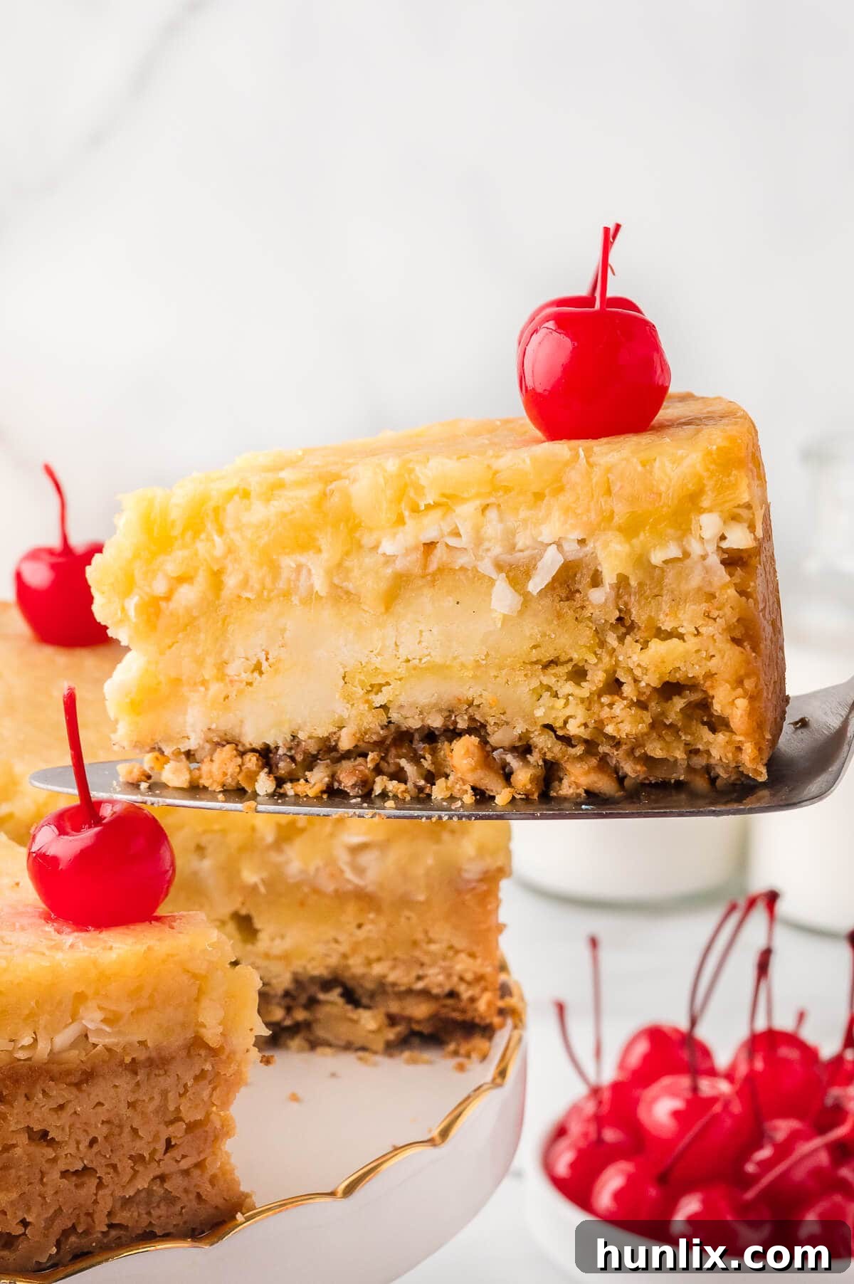 A perfectly portioned slice of Fool's Cake on a serving spatula, showcasing its layers.