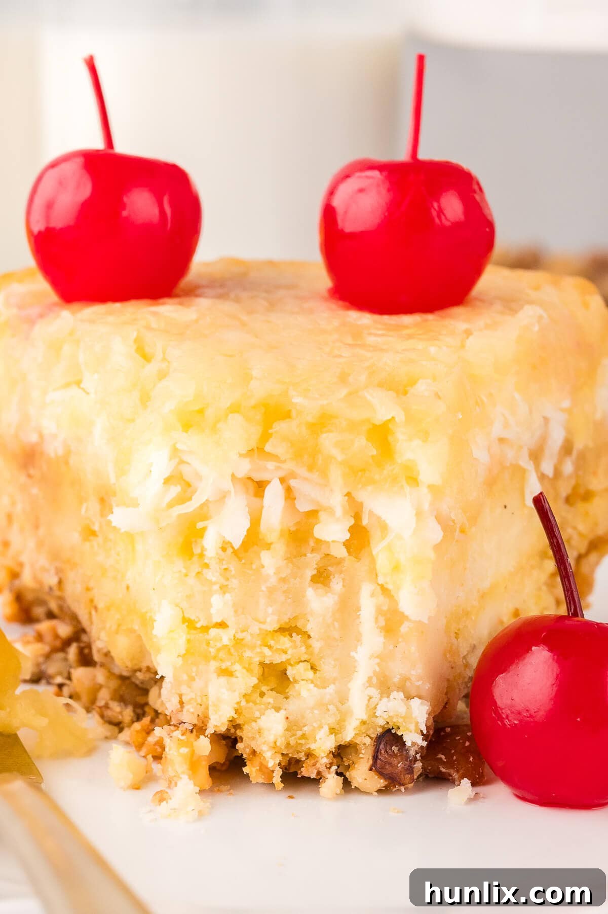 A close-up of a Fool's Cake slice on a plate, with a bite taken, revealing its delicious layers.