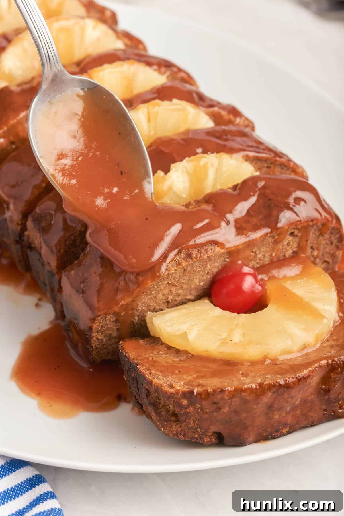 Island Spice Meatloaf 2 A spoon putting sauce on Caribbean meatloaf.