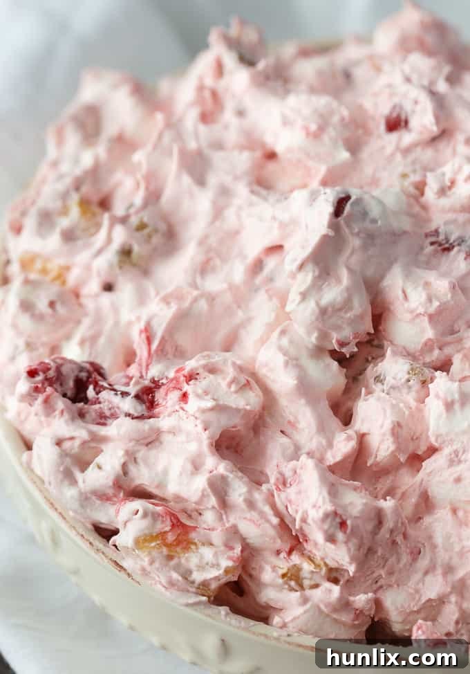 Close-up of Cherry Salad showing the creamy texture and chunks of pineapple.