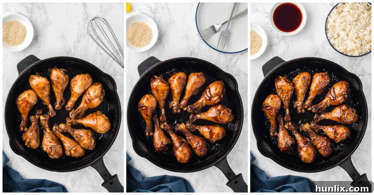 Another view of the sticky chicken cooking in a cast iron pan, showing the sauce reducing and thickening around the drumsticks.