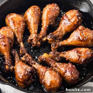 The finished sticky chicken dish in a cast iron pan.