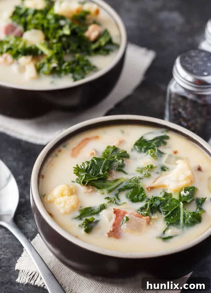 Creamy Keto Tuscan Sausage Soup 2 Keto Zuppa Toscana - A keto friendly version of the famous Tuscan soup! It's filled with kale, bacon, sausage, roasted cauliflower immersed in a creamy broth.