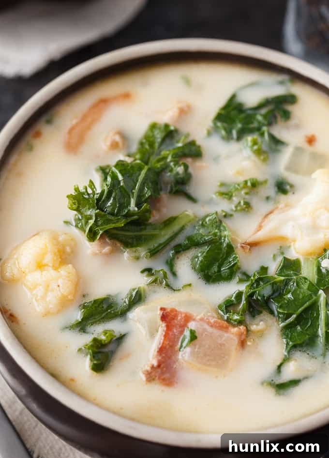 Creamy Keto Tuscan Sausage Soup 3 Keto Zuppa Toscana - A keto friendly version of the famous Tuscan soup! It's filled with kale, bacon, sausage, roasted cauliflower immersed in a creamy broth.