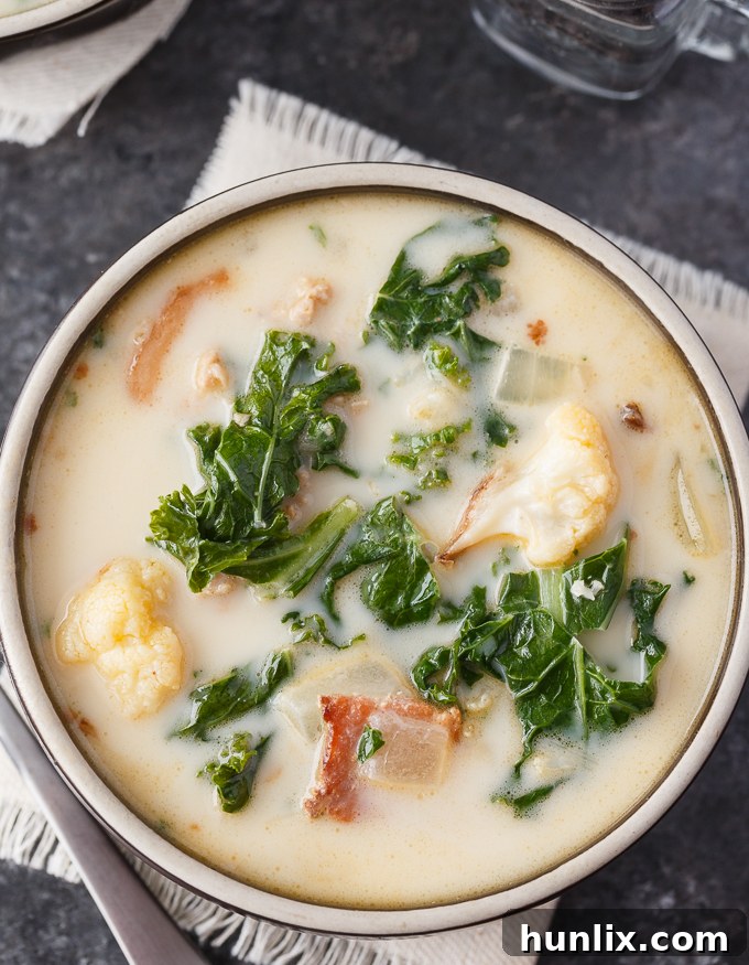 Creamy Keto Tuscan Sausage Soup 5 Keto Zuppa Toscana - A keto friendly version of the famous Tuscan soup! It's filled with kale, bacon, sausage, roasted cauliflower immersed in a creamy broth.