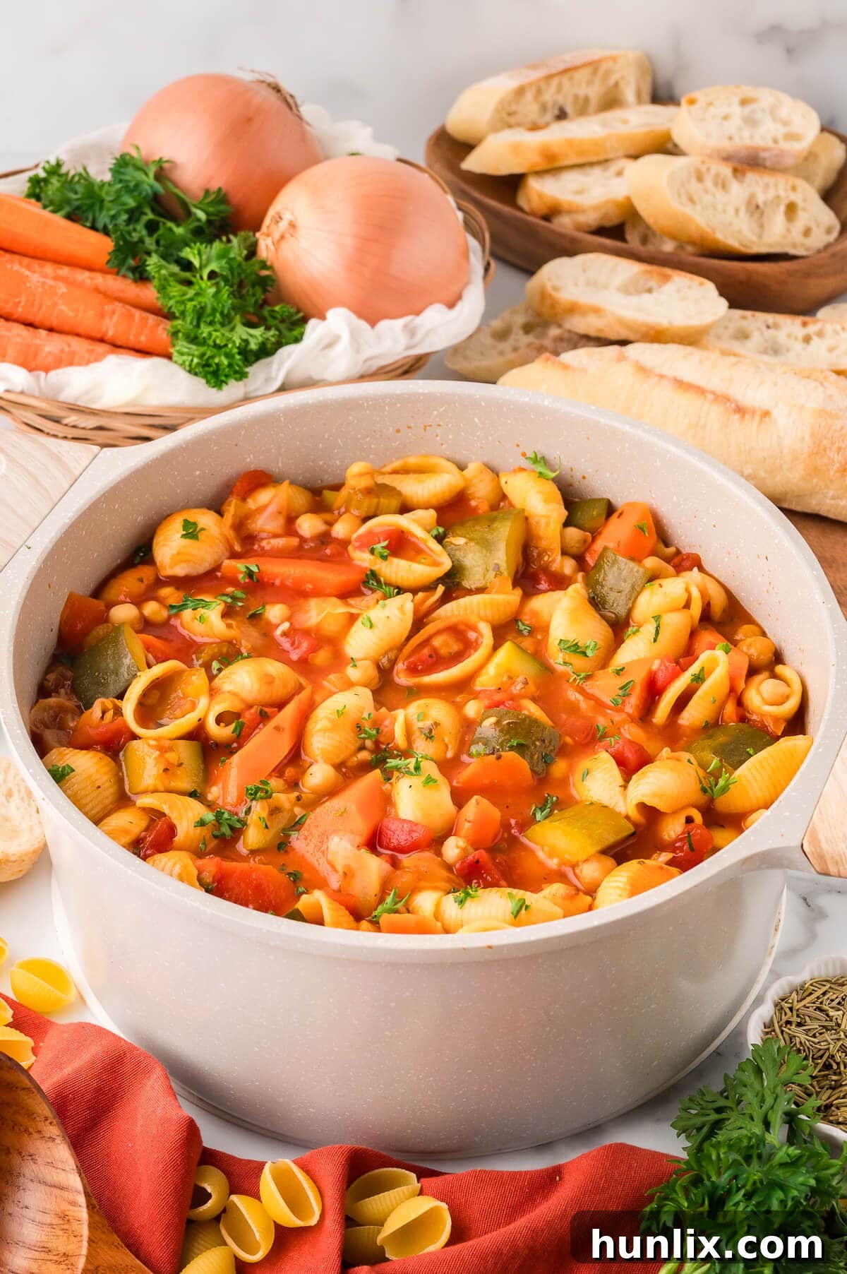 Hearty Italian Vegetable and Pasta Soup 2 A large pot of minestrone soup, freshly cooked and steaming, filled with colorful vegetables and pasta, ready to be served.