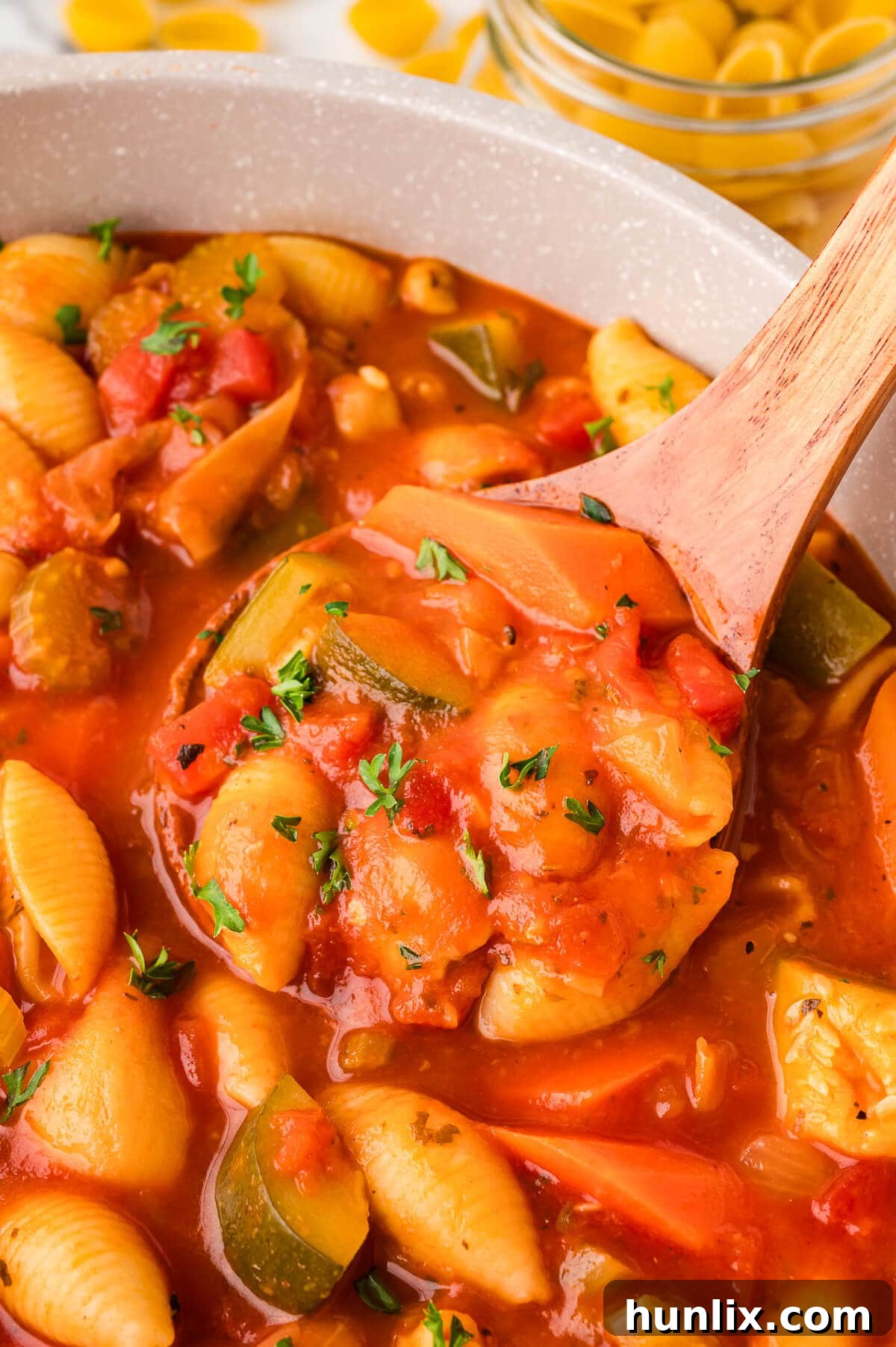 Hearty Italian Vegetable and Pasta Soup 5 A large pot of minestrone soup with a wooden serving spoon resting inside, ready for family-style serving.
