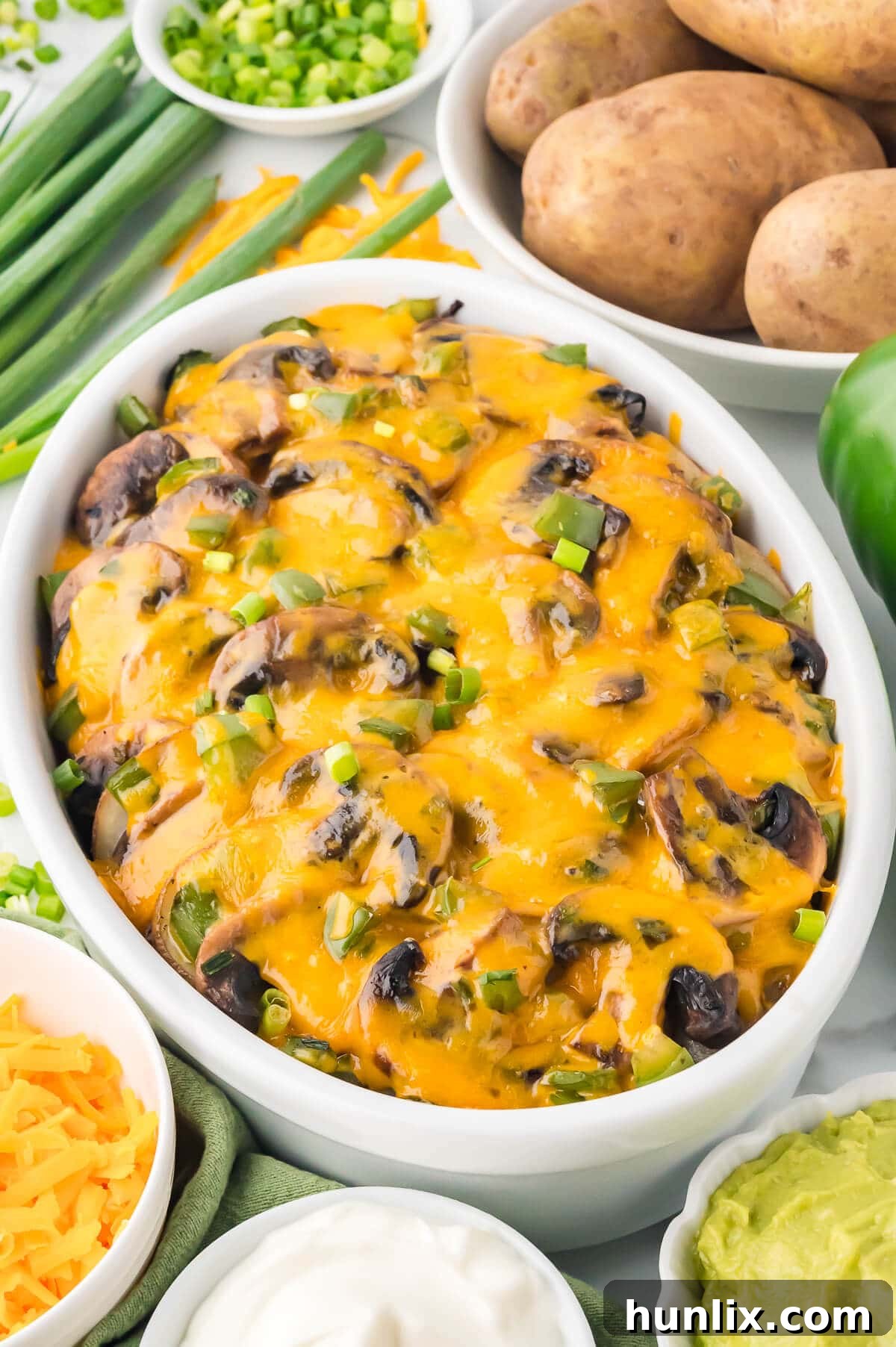 Smothered potatoes in a white casserole.