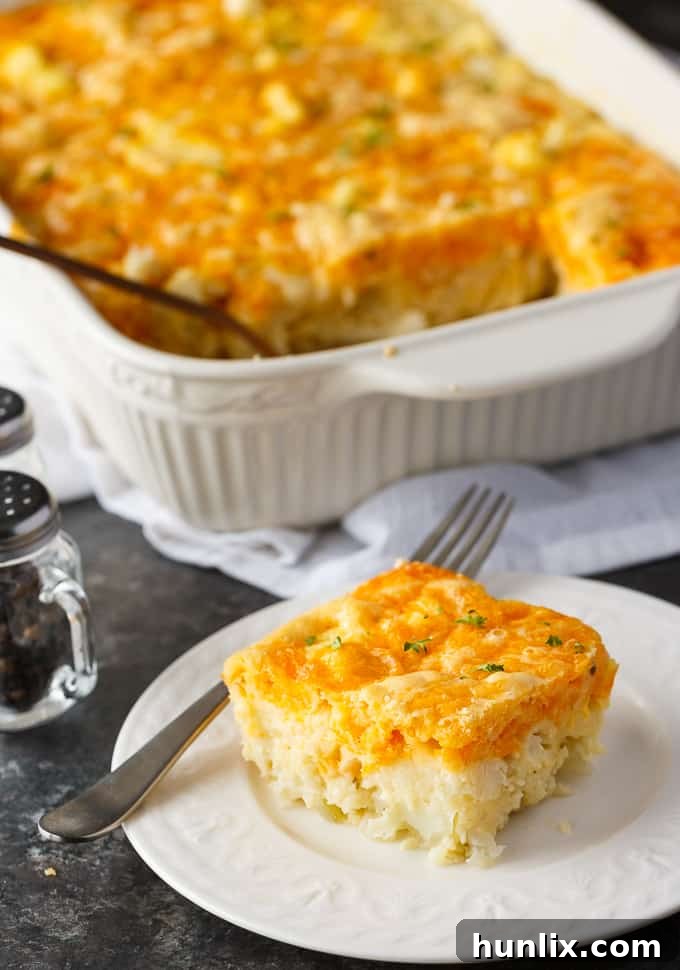 Overhead shot of the cauliflower bake in a glass casserole dish, freshly baked and ready to be served, with steam gently rising.