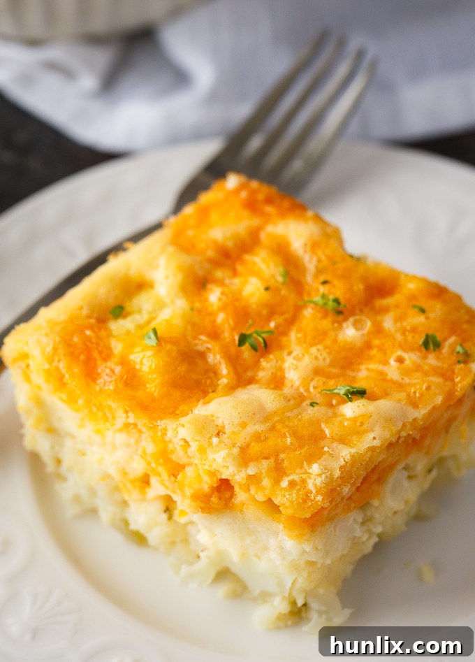 A close-up of the fully baked cauliflower casserole, glistening with melted cheese and ready to be enjoyed.