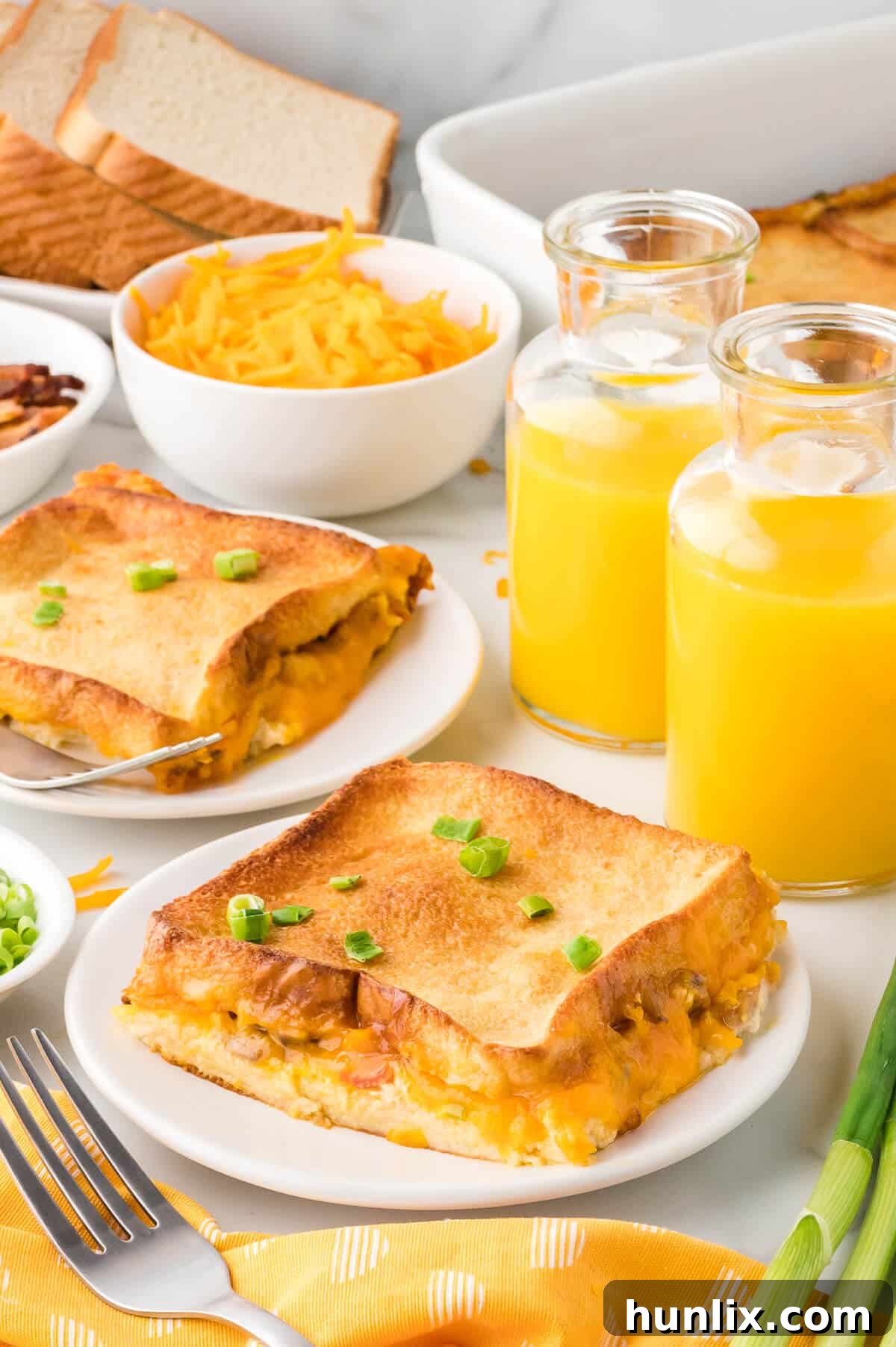 A perfectly portioned slice of bacon breakfast casserole, showcasing the layers of bread, bacon, and cheese, served on a white plate.