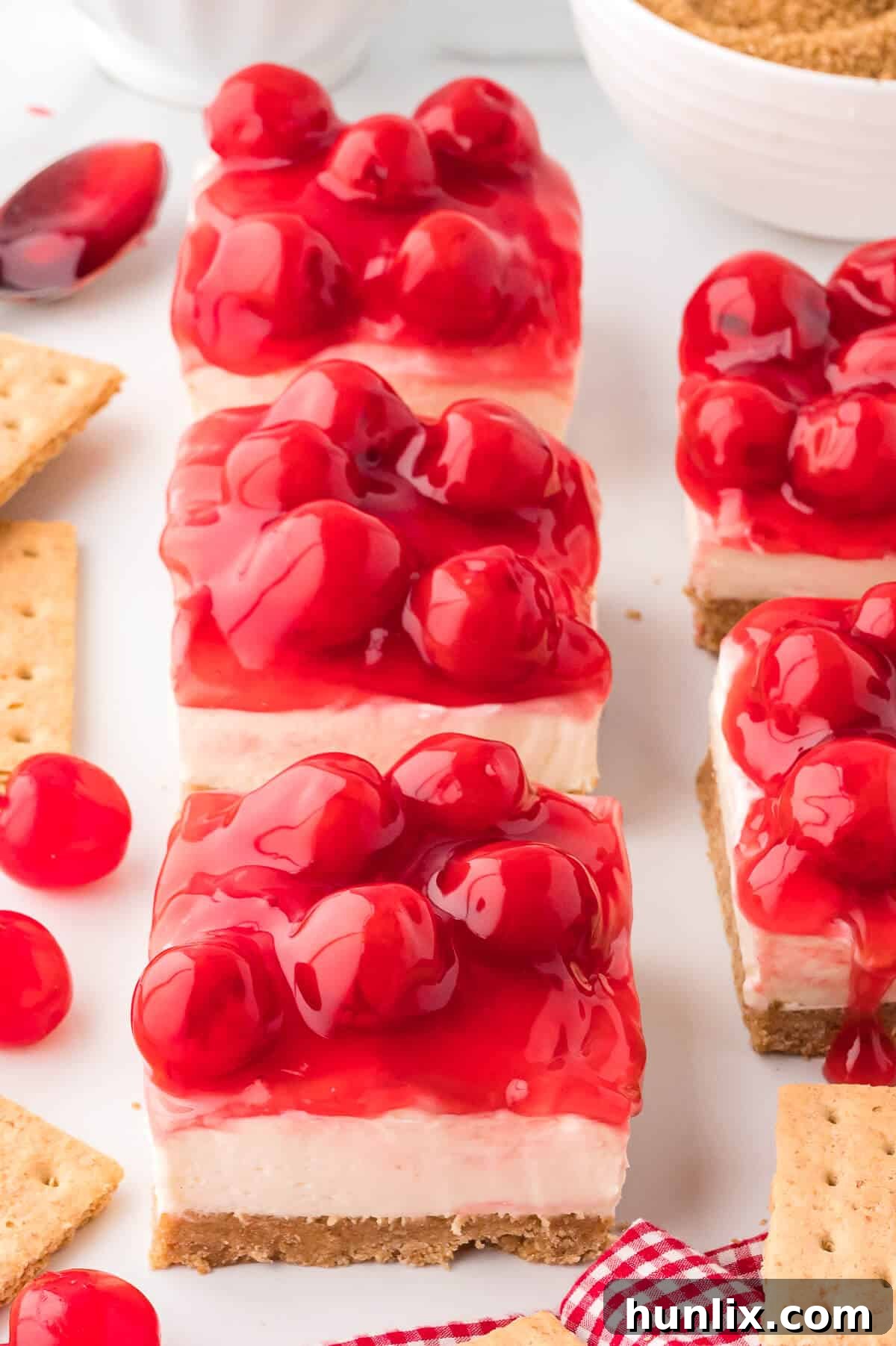 Several slices of no-bake cherry cheesecake on a serving platter.