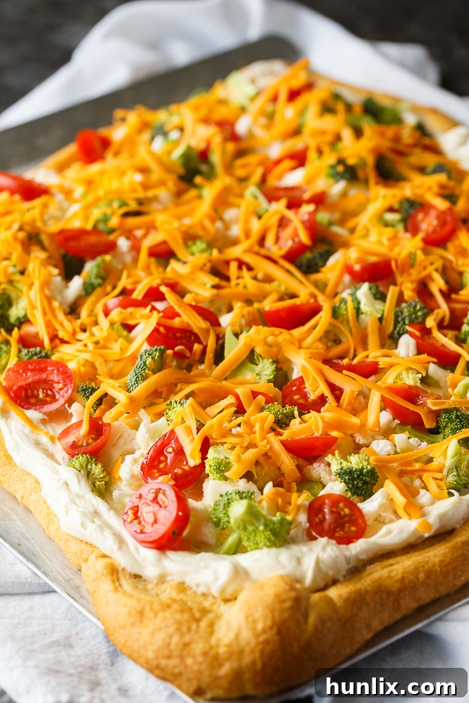 Vegetable Pizza - This easy appetizer is perfect for parties and potlucks. It's made with crescent roll dough, ranch dressing mix and loads of fresh, crispy veggies. Yum!