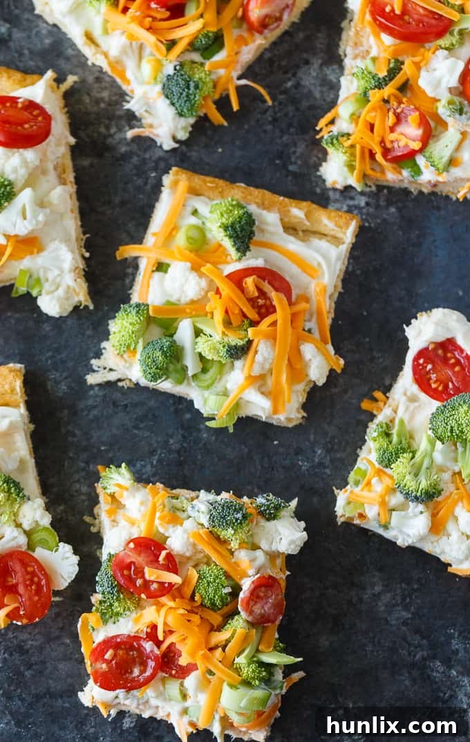 Vegetable Pizza - This easy appetizer is perfect for parties and potlucks. It's made with crescent roll dough, ranch dressing mix and loads of fresh, crispy veggies. Yum!