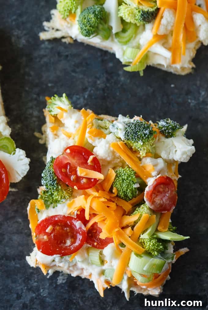 Vegetable Pizza - This easy appetizer is perfect for parties and potlucks. It's made with crescent roll dough, ranch dressing mix and loads of fresh, crispy veggies. Yum!