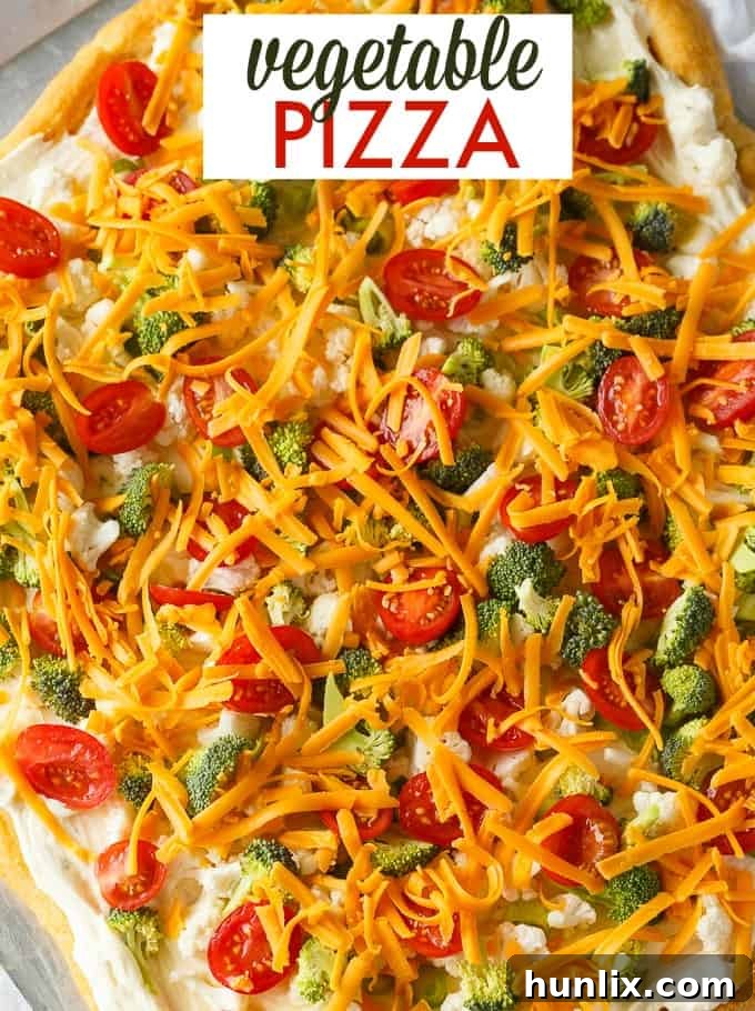 Vegetable Pizza - This easy appetizer is perfect for parties and potlucks. It's made with crescent roll dough, ranch dressing mix and loads of fresh, crispy veggies. Yum!