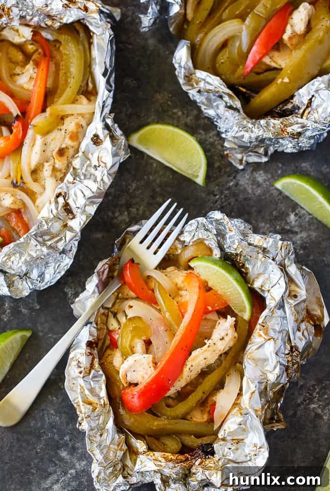 Zesty Chicken Fajita Foil Dinners 3 Chicken Fajita Foil Packets featuring vibrant peppers and onions alongside seasoned chicken, ready for grilling.