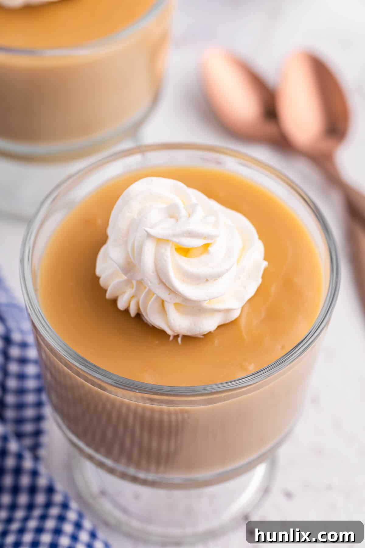 Silky Butterscotch Indulgence 10 A beautifully presented parfait dish brimming with smooth, golden butterscotch pudding, ready to be enjoyed.