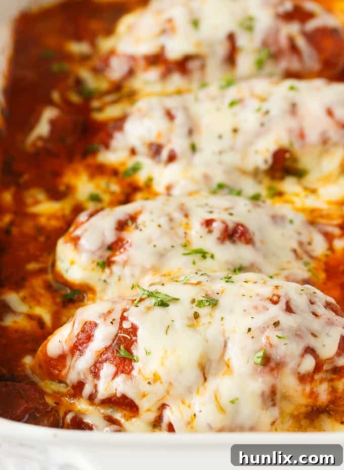 Lasagna Stuffed Chicken - Keto comfort food! Tender chicken breasts are stuffed with a ricotta filling and smothered in marinara sauce and mozzarella cheese.