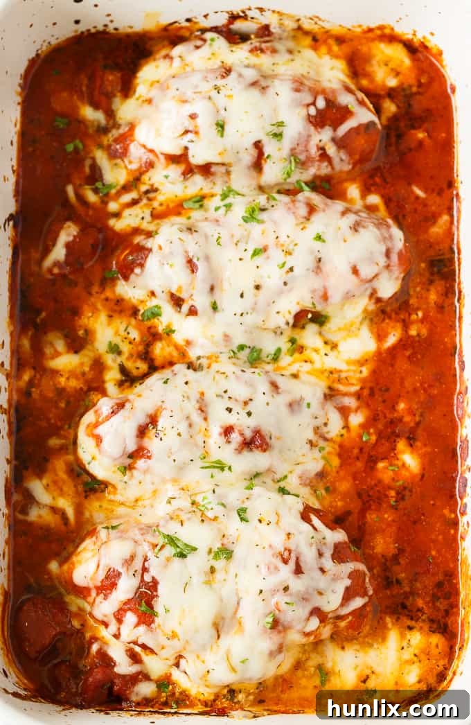 Lasagna Stuffed Chicken - Keto comfort food! Tender chicken breasts are stuffed with a ricotta filling and smothered in marinara sauce and mozzarella cheese.