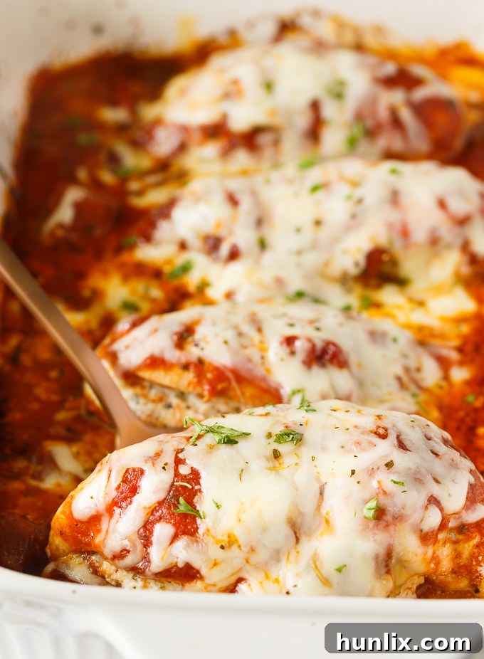 Lasagna Stuffed Chicken - Keto comfort food! Tender chicken breasts are stuffed with a ricotta filling and smothered in marinara sauce and mozzarella cheese.