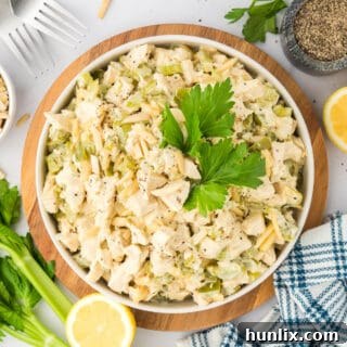 Hearty Chicken Bake 11 A white bowl of hot chicken salad with a spoon.