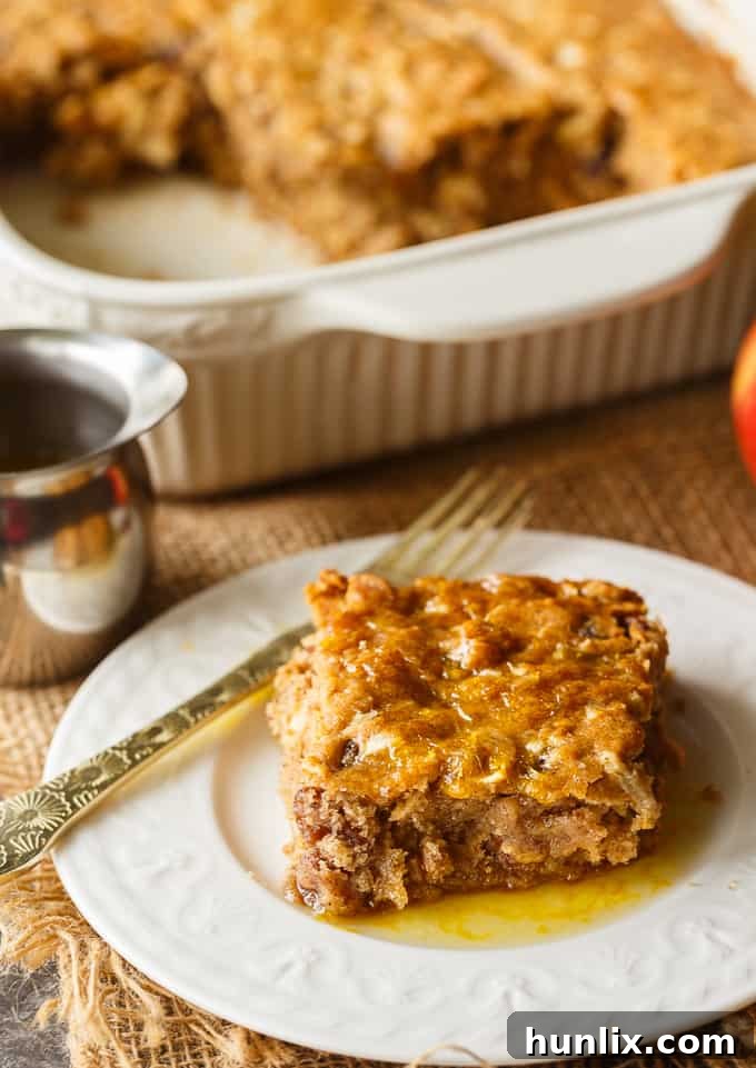 Apple Spice Cake - A sweet fall cake made with apples, raisins and spices and topped with a delicious orange glaze. #apples #spicecake