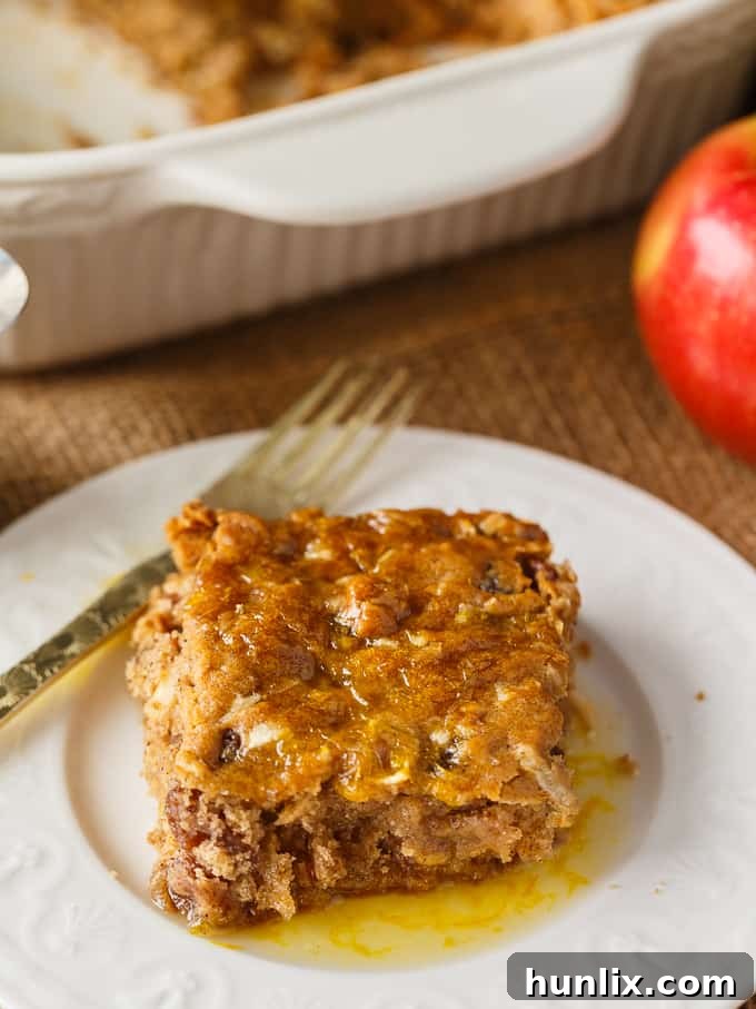 Apple Spice Cake - A sweet fall cake made with apples, raisins and spices and topped with a delicious orange glaze. #apples #spicecake