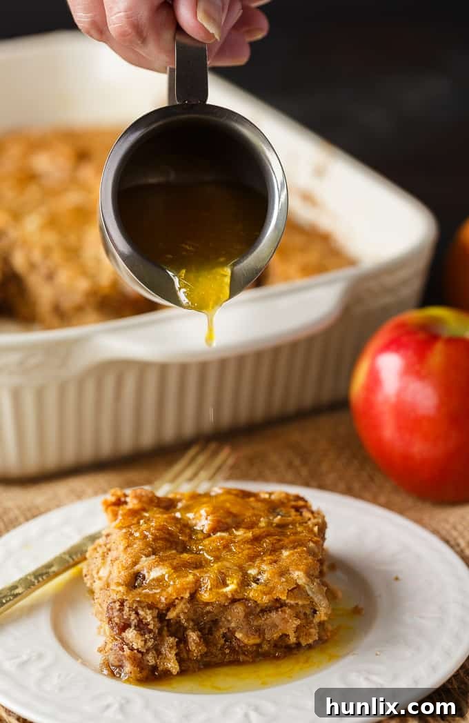 Apple Spice Cake - A sweet fall cake made with apples, raisins and spices and topped with a delicious orange glaze. #apples #spicecake