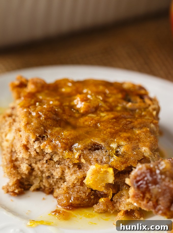 Apple Spice Cake - A sweet fall cake made with apples, raisins and spices and topped with a delicious orange glaze. #apples #spicecake