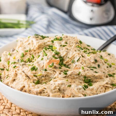 Dreamy Slow Cooker Cream Cheese Chicken 9 The recipe in a bowl with a spoon.