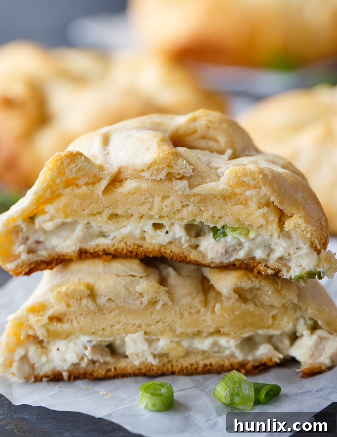 Golden Chicken Surprises 5 Baked chicken bundles on a baking sheet, showcasing their golden crust and savory filling.