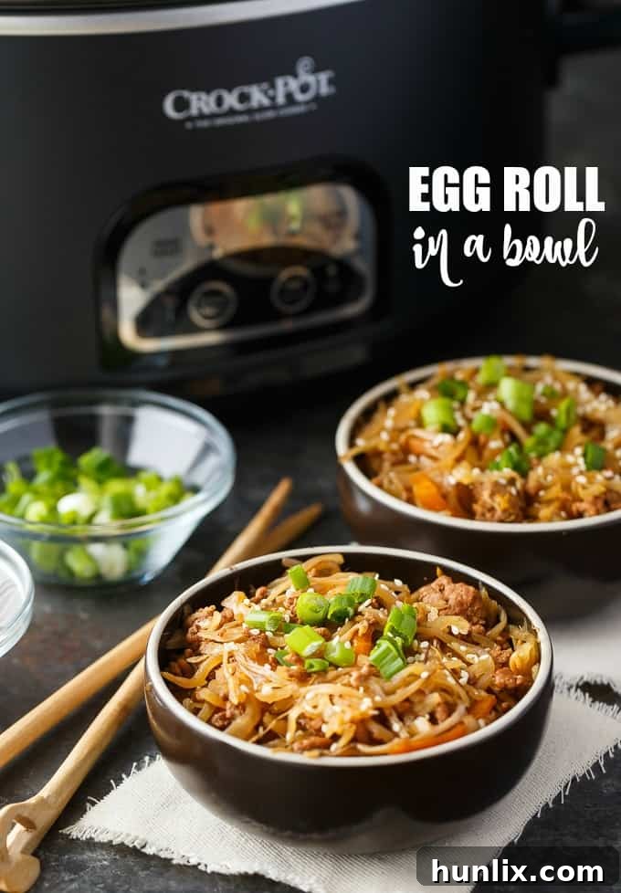 A vibrant close-up of Egg Roll in a Bowl, showcasing ground pork, colorful coleslaw mix, and garnishes, prepared in a Crock-Pot slow cooker for an easy, healthy weeknight meal.
