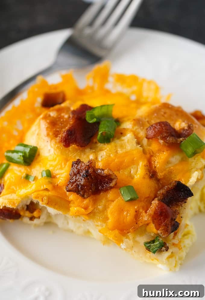 Overhead shot of Bacon and Egg Biscuit Casserole in a white baking dish, freshly baked.