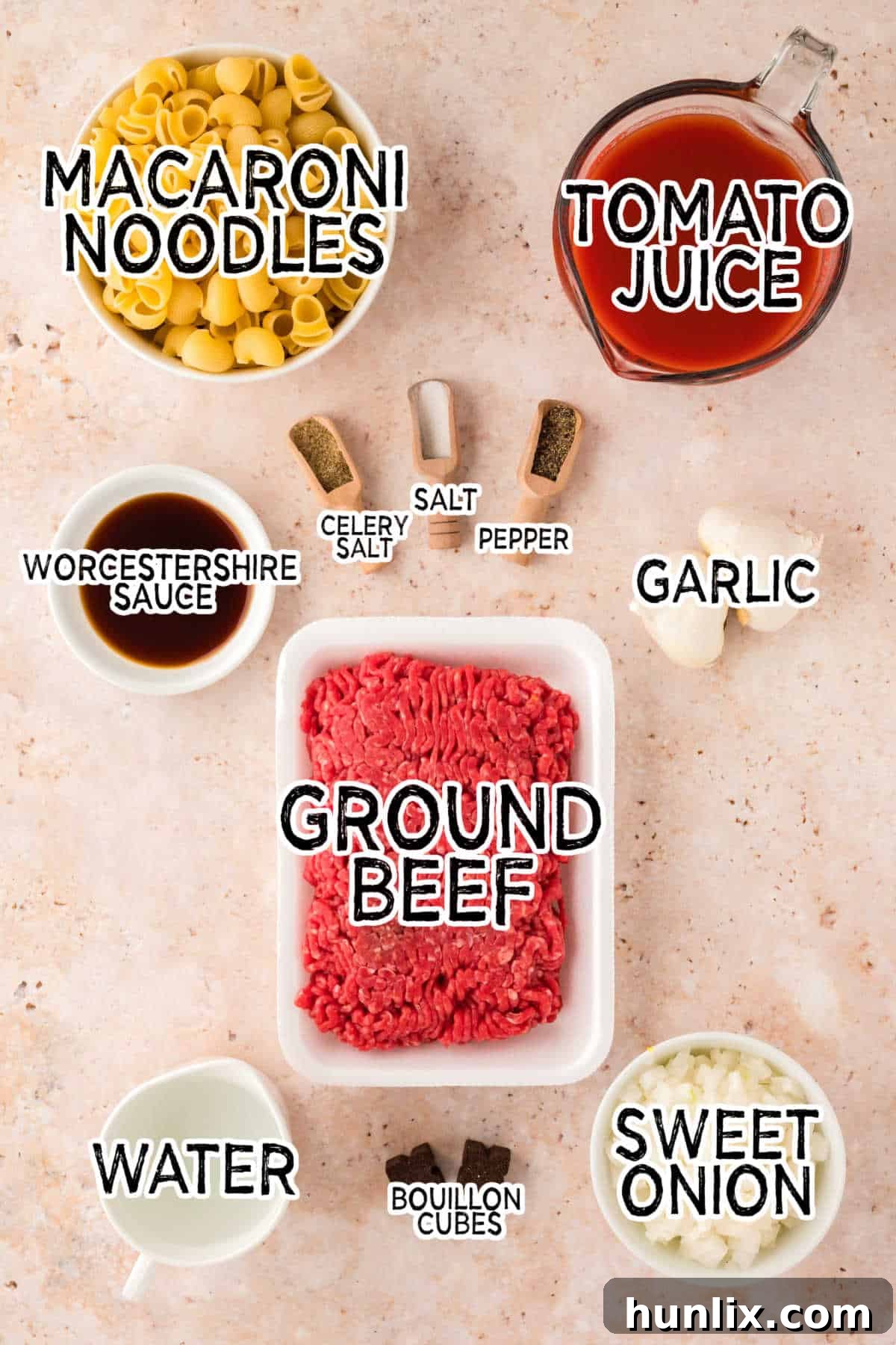 Various ingredients laid out for making Grandma's Goulash, including ground beef, onions, garlic, and macaroni.