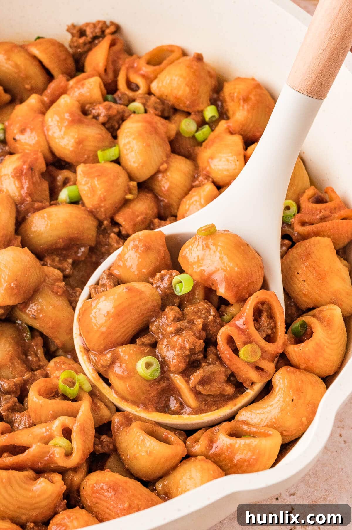 A pot of grandma's goulash with a ladle, ready to serve.