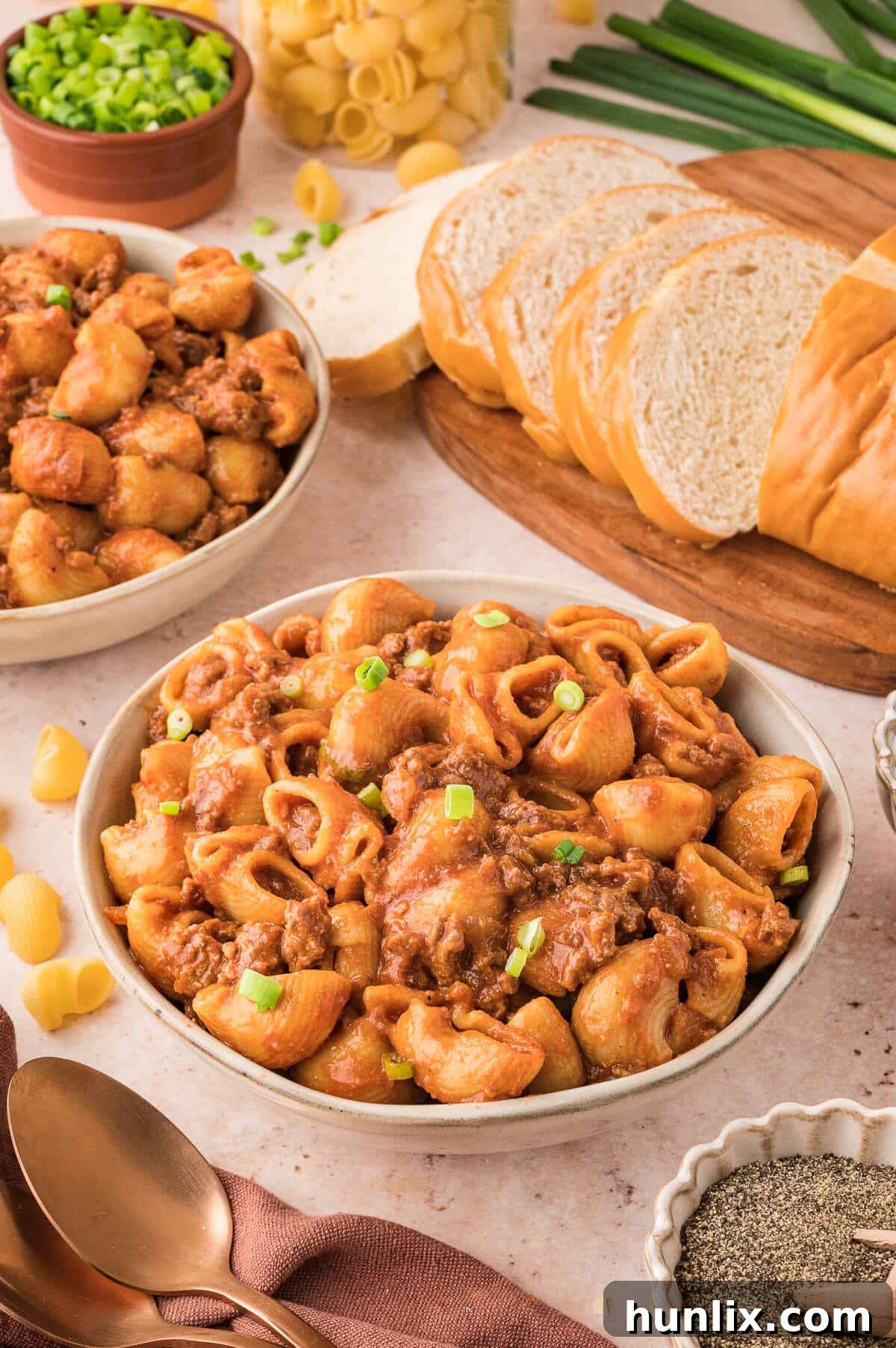 A bowl of Grandma's Goulash, topped with fresh green onions.