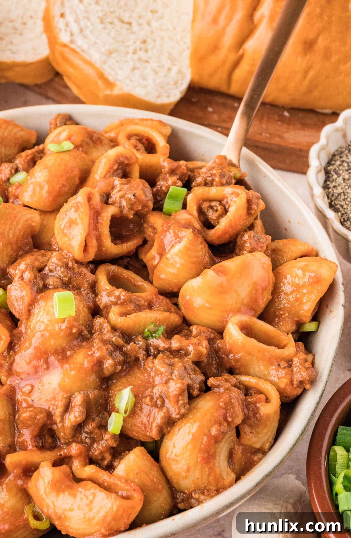 Grandma's Goulash in a bowl with a spoon, ready to eat.