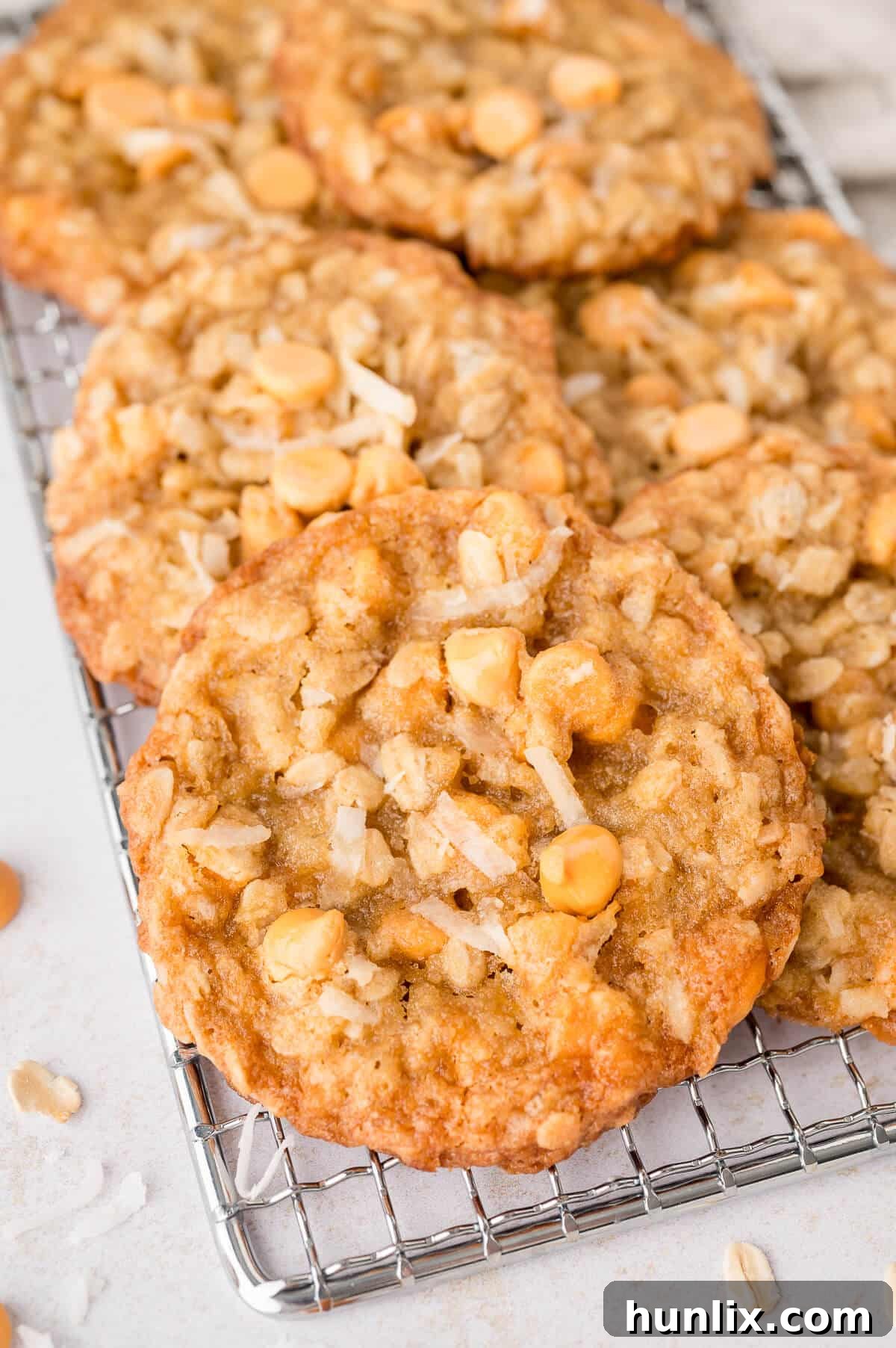 Golden brown Coconut Butterscotch Cookies resting on a wire rack, ready to be enjoyed.