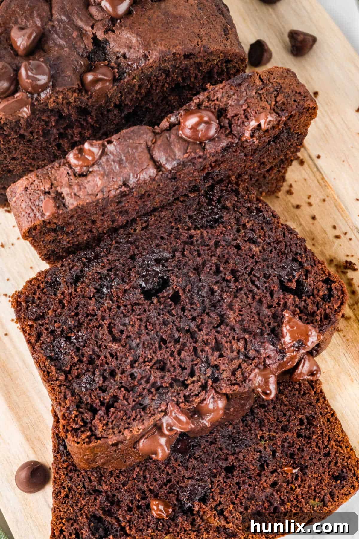Slices of chocolate zucchini bread on a cutting board.