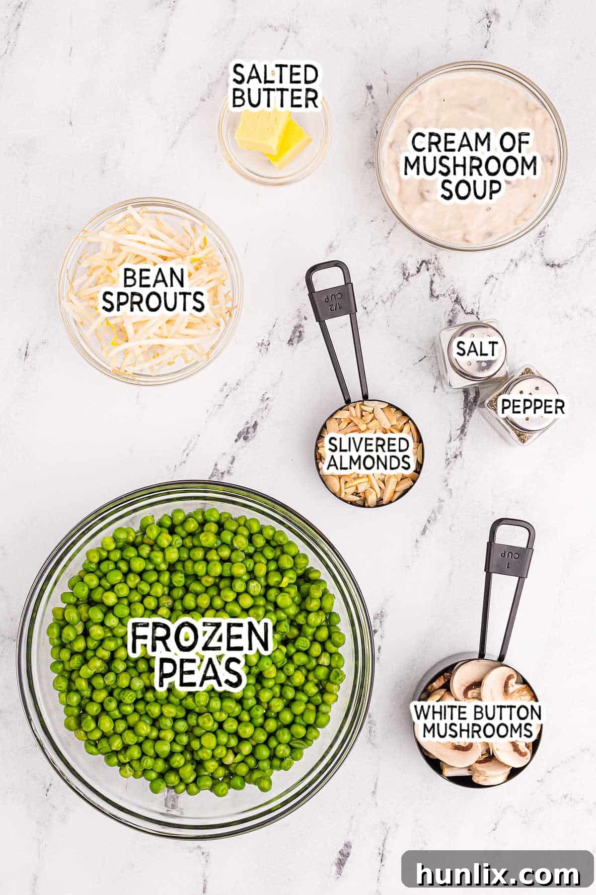 A flat lay photograph showcasing all the ingredients required to make Company Peas, neatly arranged on a kitchen counter.