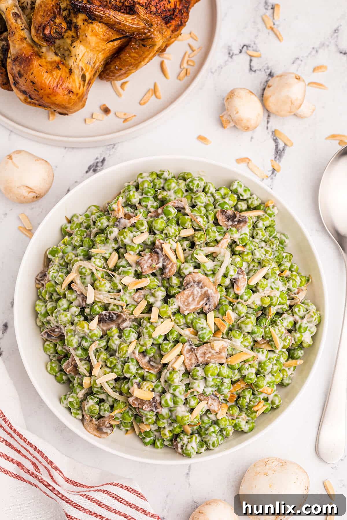 A generous serving of Company Peas in a white bowl, ready to be enjoyed as a side dish.
