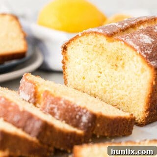 A beautifully glazed loaf of lemon bread, ready to be served.