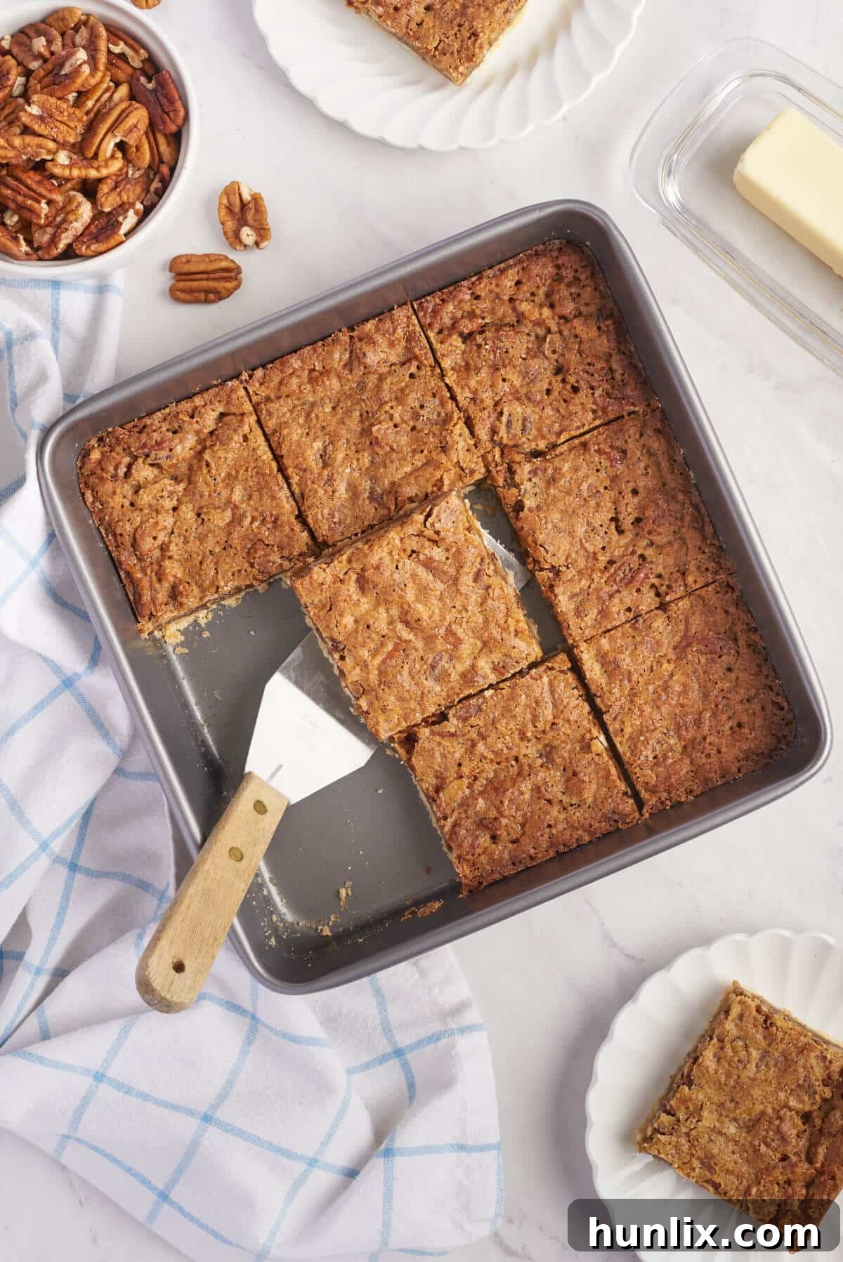 Delicious Butter Tart Squares cooling in a baking pan, ready to be cut and served.