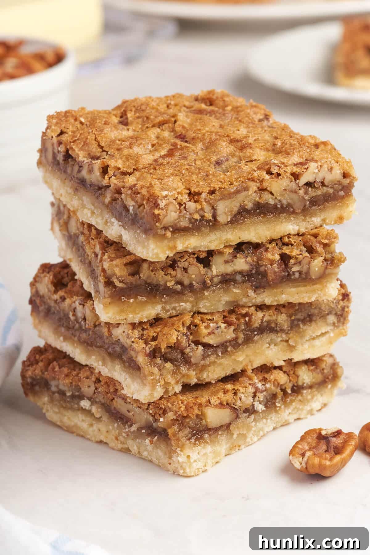 A delectable stack of Butter Tart Squares, invitingly arranged to showcase their irresistible layers.