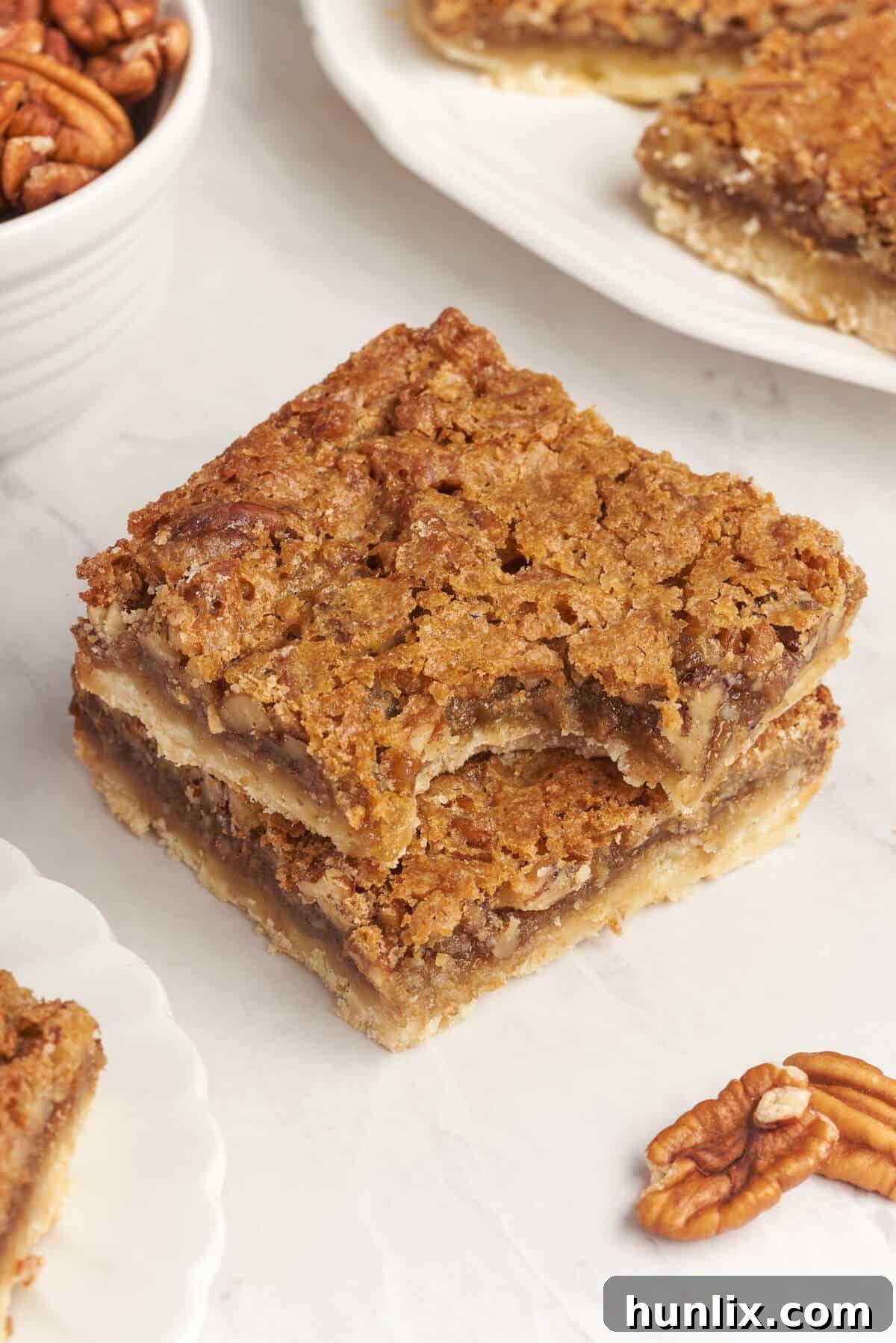 A perfectly baked Butter Tart Square with a bite taken out, revealing its rich, gooey filling and crisp crust.