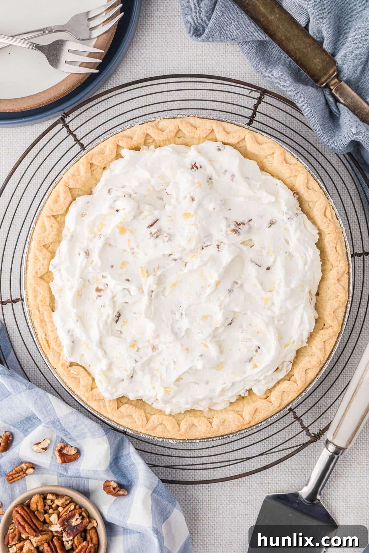 A beautifully set Millionaire Pie, sliced and ready to serve on a elegant wire platter, showcasing its creamy texture and pecan topping.